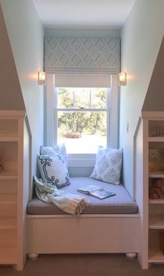 a window seat with books on it in the corner