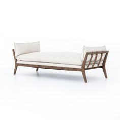 a white couch sitting on top of a wooden frame