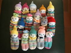 a group of knitted dolls sitting next to each other