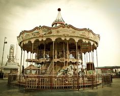 an old fashioned merry go round with horses on it