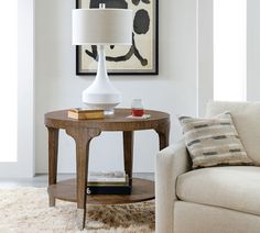 a living room scene with focus on the end table and lamp in the center area