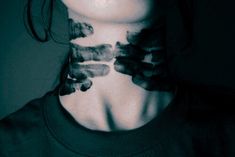 a woman with her neck covered in black and white ink