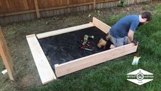 a man working on an outdoor play area in the yard with toys and construction equipment