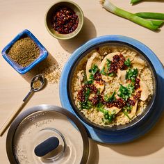 a blue bowl filled with rice and broccoli on top of a wooden table