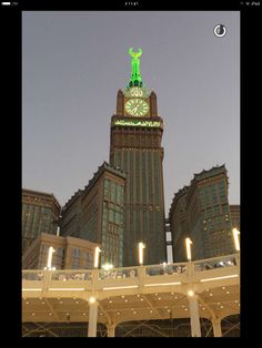 a large building with a clock on it's side in the middle of night