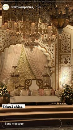 an ornate room with chandeliers and flowers