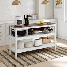 a kitchen island with food on it in front of white cabinets and countertop space