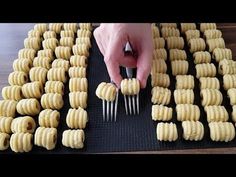 a person is cutting up some food on a table with forks and knives in front of them