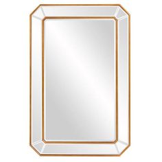 a gold and white mirror on a white background with the reflection of an object in it