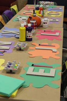 the table is covered with paper cutouts and crafting supplies for arts and crafts