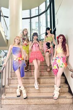 the girls are all dressed up and posing on the stairs in front of some windows