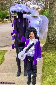 two people dressed up in costumes and one is holding a guitar