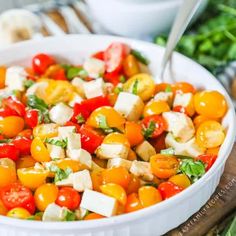 a white bowl filled with tomatoes and feta cheese