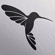 a black and white hummingbird flying in the air