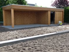 a large wooden building sitting on top of a dirt field