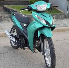 a blue motorcycle parked on the side of the road