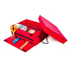 a red box with scissors and other items in it