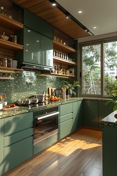 a kitchen with green cabinets and wooden floors is seen in this image, while the light shines on the counter tops