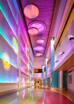 an image of a hallway with colorful lights on the ceiling and floor in front of it