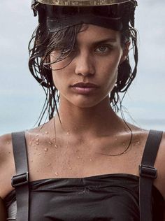 a woman with wet hair and a hat on her head