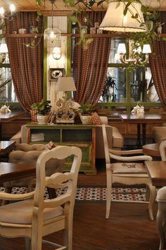 a living room filled with lots of furniture and windows covered in curtains next to each other