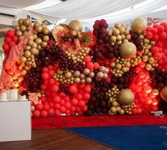 balloons are hanging on the wall in front of a red carpeted area with a blue rug