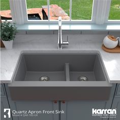 a kitchen sink sitting on top of a counter next to a window