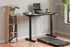 a laptop computer sitting on top of a wooden desk next to a plant and bookshelf