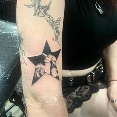 a woman with a star tattoo on her arm