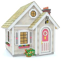 a paper model of a house with a pink door and window on the front porch