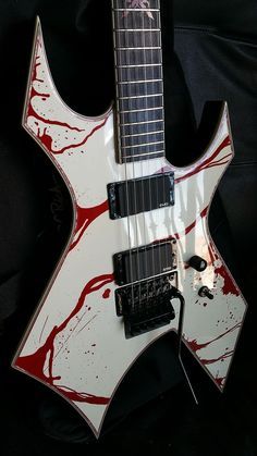 an electric guitar with red and white paint on it