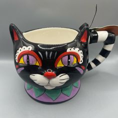 a black and white cat mug with red eyes