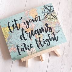 a sign that says let your dreams take flight on top of a wooden easel