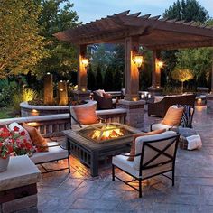 an outdoor patio with seating and fire pit