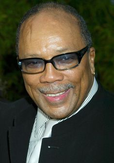 an older man wearing glasses and a suit