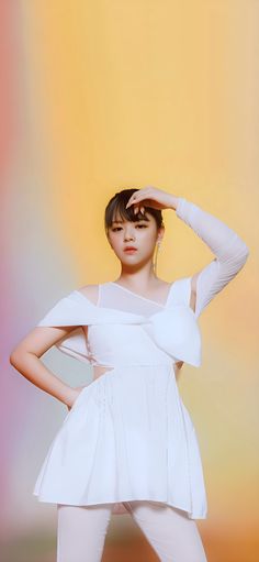 a woman in white is posing with her hands on her head