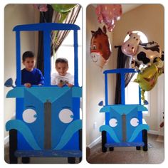 two children in a blue train cart with balloons on the ceiling and one boy smiling