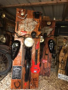 there are many different types of guitars and motorcycles in this shop, all made out of wood