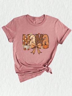 Introducing our Fall Mama Tee, the perfect addition to your autumn wardrobe!  This Pumpkin Mom Shirt is not just a stylish piece, but also a thoughtful Fall Mom Gift for yourself or the special mama in your life. Embrace the Pumpkin Season and showcase your motherly love with this charming design. Crafted with care, this Gift For Mama tee is made from high-quality fabric ensuring maximum comfort and durability. You'll be able to enjoy the cozy vibes of autumn while wearing this Fall Mom Tee.  Whether it's for Halloween or just a fun night out, this shirt is sure to turn heads and make you the coolest Halloween Mom in town!Fall Mama Shirt, Fall Mom T-Shirt, Fall Mama Coquette Pumpkin Mama Shirt, Fall Season Mom Gift, Fall Mama Tee, Halloween Mama Shirt Mauve Heather Casual  Short Sleeve  An Pink T-shirt With Funny Print For Fall, Pink Graphic Print T-shirt For Fall, Cute Funny Print Shirt For Fall, Pink Funny Print T-shirt For Fall, Pink Graphic Print Shirt For Fall, Pink Letter Print Shirt For Fall, Cute Pink Fall Shirt, Cute Pink Shirt For Fall, Pink T-shirt For Fall