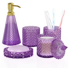 a purple bathroom set with toothbrushes and soap dispenser