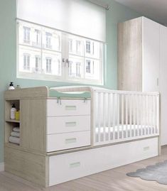 a baby's room with a crib and dresser