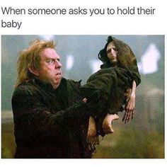 a man holding a baby in his arms with the caption when someone asks you to hold their baby