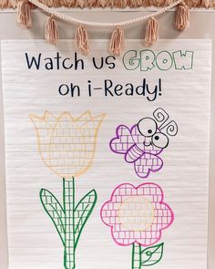 a sign that says watch us grow on i - ready with flowers and a bee