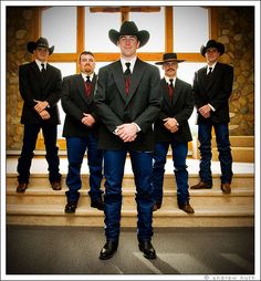 a group of men in suits and hats standing on steps with their hands behind their backs