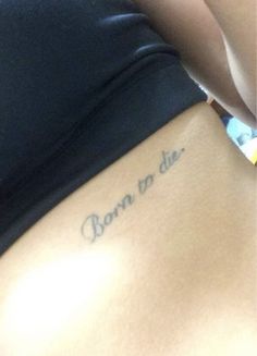 the back of a woman's stomach with writing on it that says born to die