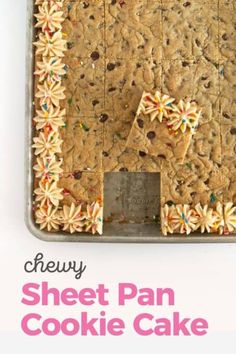 a sheet pan cookie cake with sprinkles and flowers on the side, cut into squares