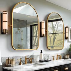 a bathroom with two sinks, mirrors and lights on the wall next to each other