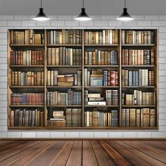 an empty room with bookshelves full of books and lamps hanging from the ceiling