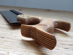 a pair of scissors sitting on top of a wooden table next to a knife blade