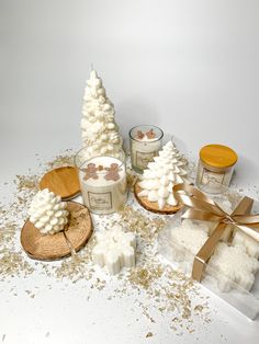 some candles are sitting next to each other on a table with snow flakes all over them